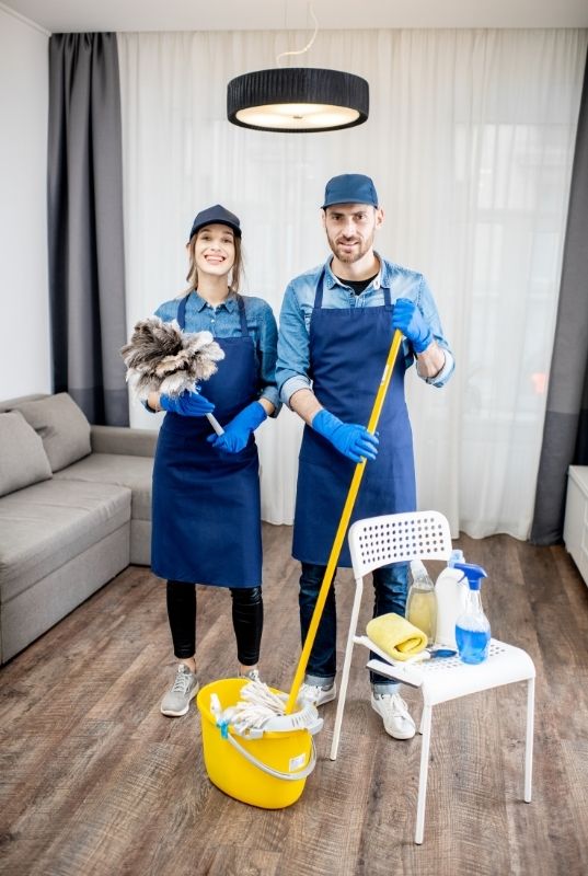 Two cleaners mopping floor and dusting