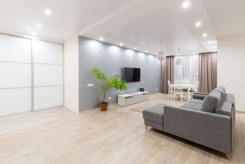 Residential living room unit lighted with LED. There are some furniture like sofa, coffee table and TV