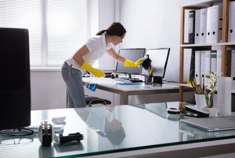 Maid wiping a monitor for an office cleaning services in Newcastle, NSW
