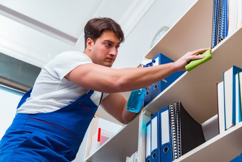 Man cleaning an office furniture in Central Coast