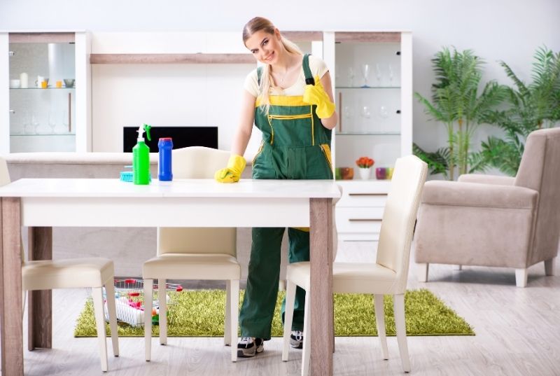 Central coast cleaner wiping a table for a residential customer